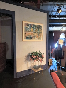 A partial view of the Iowa City Community Theatre set for the play Significant Other including a watercolor painting by Jo Myers-Walker